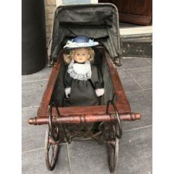 Antieke poppenwagen met pop
